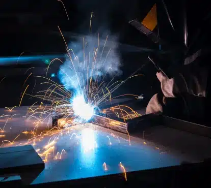 Welder joining steel tubing with a bright welding arc in Illinois