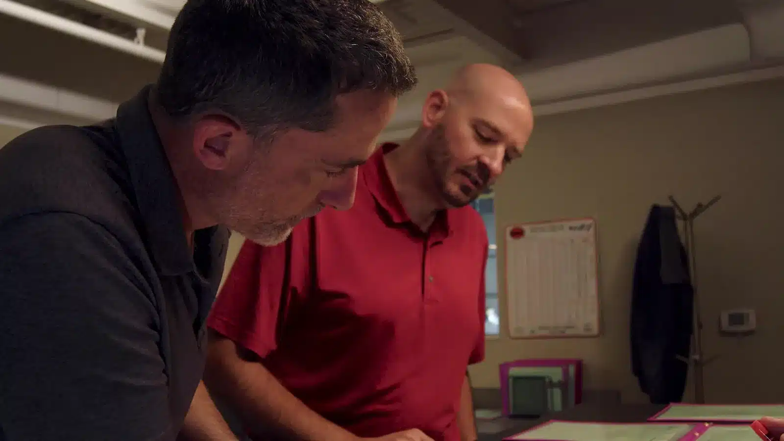 Two Versatile Fabrication team members reviewing project details together in Michigan